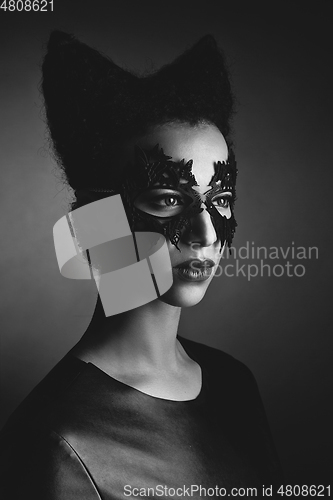 Image of girl with horns hairstyle in leather mask