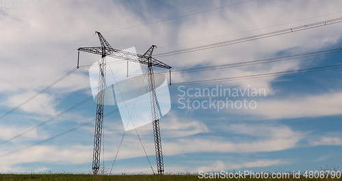 Image of cloudy morning sky and a high-voltage line