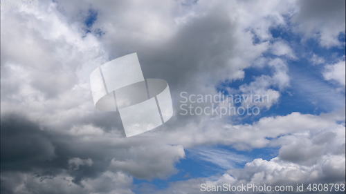 Image of Time lapse Fluffy clouds float across the blue sky. UltraHD stock footage