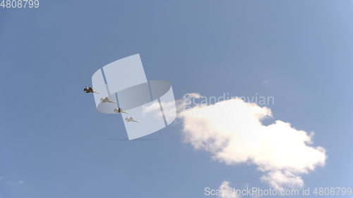 Image of Four fighters Mig-31 fly in blue sky