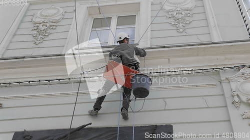 Image of MOSCOW - JUNE 7: Climber spends repair work on a multi-storey building height on June 7, 2017 in Moscow, Russia. UltraHD stock footage