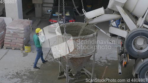 Image of MOSCOW - AUGUST 26: Concrete mixer with is with poured cement slurry into the tank. on August 26, 2017 in Moscow, Russia