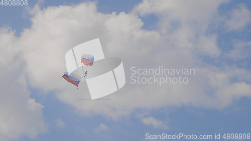 Image of MOSCOW - SEP 2: the paratrooper descends on a parachute with the flag of Russia at a celebration in honor of the 70th anniversary of the launch of the first aircraft An-2 on September 2, 2017 in Mosco