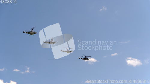Image of Combat helicopters Ka-52 fly in blue sky