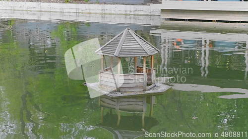 Image of Wooden Duck House on a Pond in Rural.