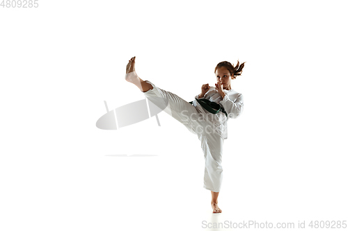 Image of Confident junior in kimono practicing hand-to-hand combat, martial arts