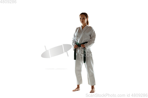 Image of Confident junior in kimono practicing hand-to-hand combat, martial arts