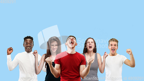 Image of Portrait of multiethnic group of young people isolated on blue studio background, flyer, collage