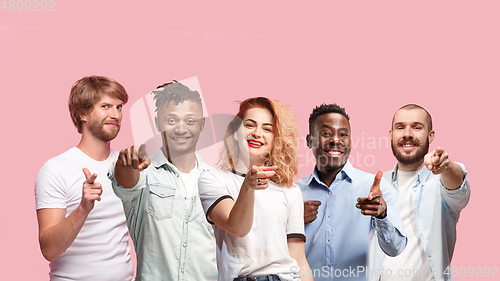 Image of Portrait of multiethnic group of young people isolated on pink studio background, flyer, collage