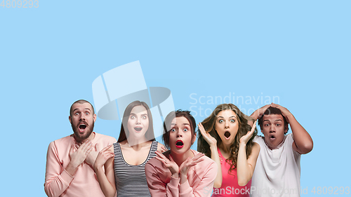 Image of Portrait of multiethnic group of young people isolated on blue studio background, flyer, collage