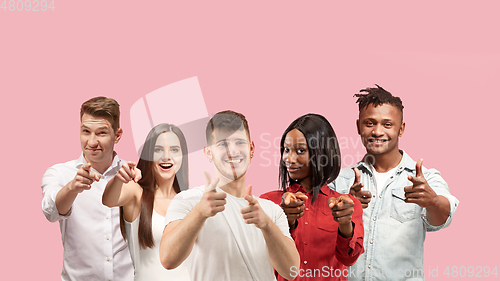 Image of Portrait of multiethnic group of young people isolated on pink studio background, flyer, collage