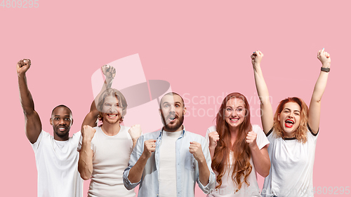 Image of Portrait of multiethnic group of young people isolated on pink studio background, flyer, collage