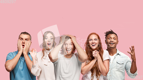 Image of Portrait of multiethnic group of young people isolated on pink studio background, flyer, collage