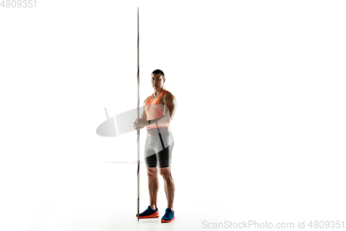 Image of Male athlete practicing in throwing javelin isolated on white studio background