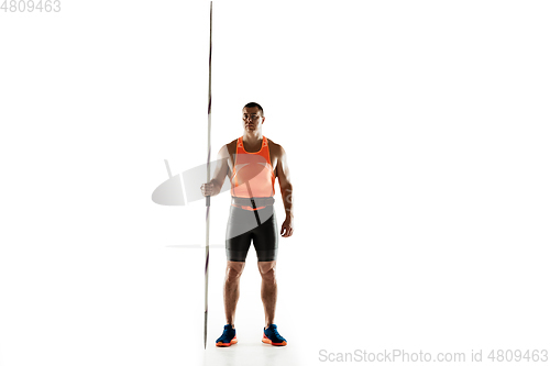 Image of Male athlete practicing in throwing javelin isolated on white studio background