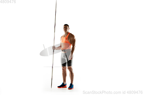 Image of Male athlete practicing in throwing javelin isolated on white studio background