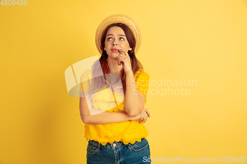 Image of Caucasian woman\'s portrait isolated on yellow studio background