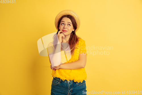 Image of Caucasian woman\'s portrait isolated on yellow studio background