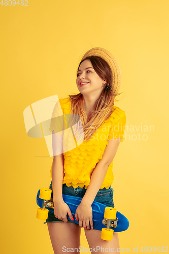 Image of Caucasian woman\'s portrait isolated on yellow studio background