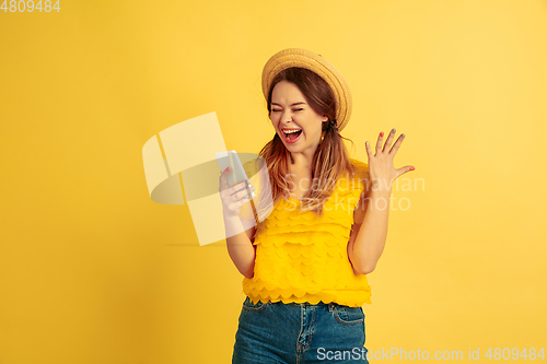 Image of Caucasian woman\'s portrait isolated on yellow studio background