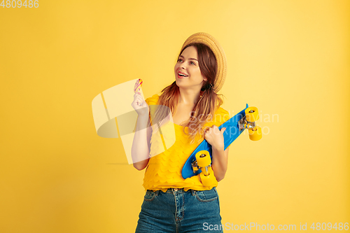 Image of Caucasian woman\'s portrait isolated on yellow studio background