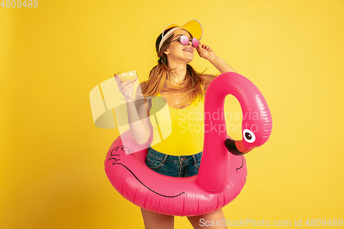 Image of Caucasian woman\'s portrait isolated on yellow studio background