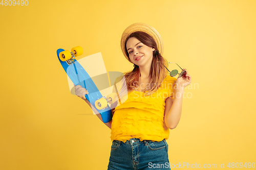 Image of Caucasian woman\'s portrait isolated on yellow studio background