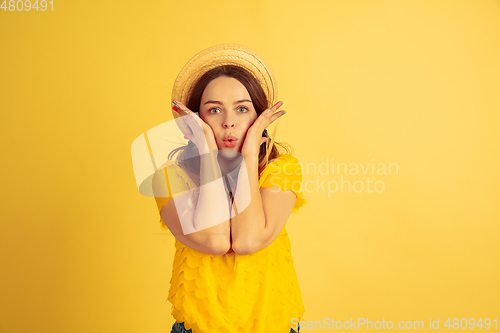Image of Caucasian woman\'s portrait isolated on yellow studio background