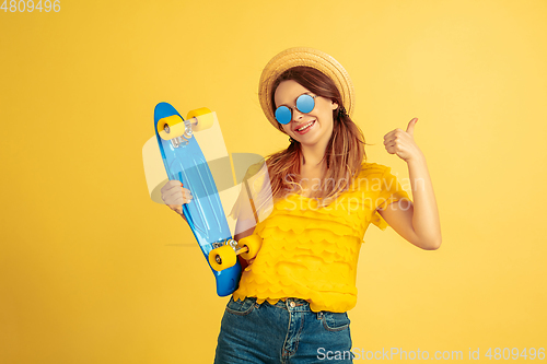 Image of Caucasian woman\'s portrait isolated on yellow studio background