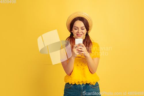 Image of Caucasian woman\'s portrait isolated on yellow studio background