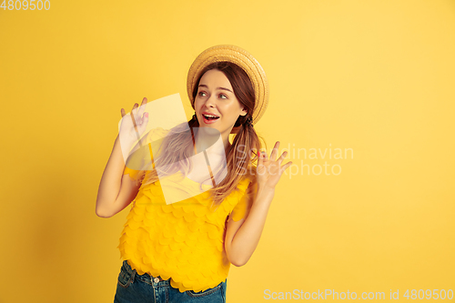 Image of Caucasian woman\'s portrait isolated on yellow studio background