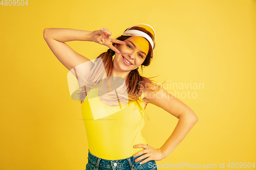 Image of Caucasian woman\'s portrait isolated on yellow studio background