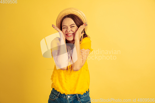 Image of Caucasian woman\'s portrait isolated on yellow studio background