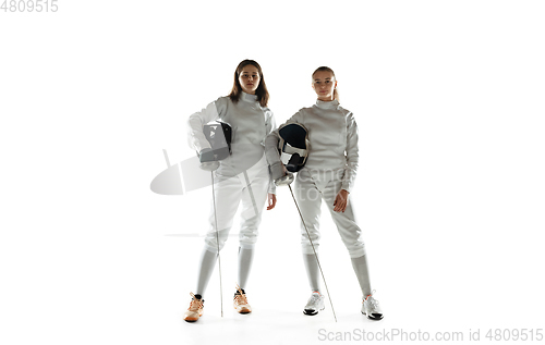 Image of Teen girls in fencing costumes with swords in hands isolated on white background, flyer