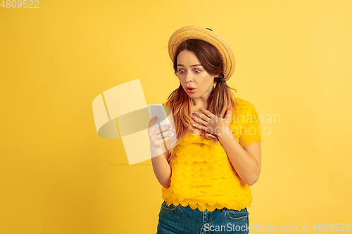 Image of Caucasian woman\'s portrait isolated on yellow studio background