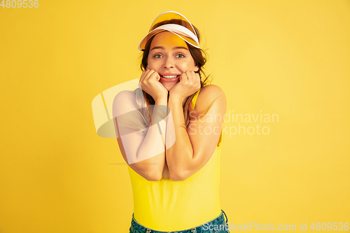 Image of Caucasian woman\'s portrait isolated on yellow studio background