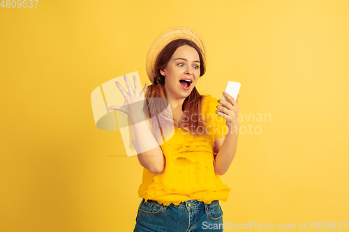 Image of Caucasian woman\'s portrait isolated on yellow studio background