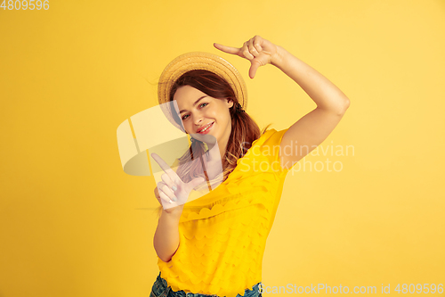 Image of Caucasian woman\'s portrait isolated on yellow studio background