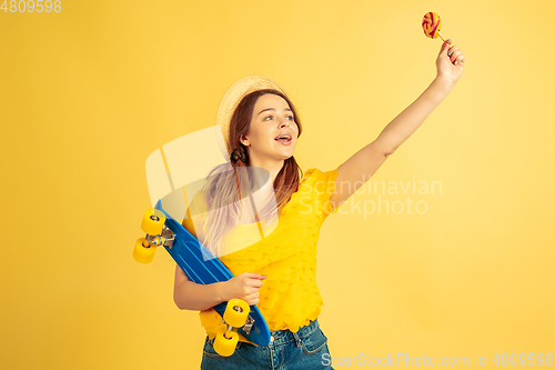 Image of Caucasian woman\'s portrait isolated on yellow studio background