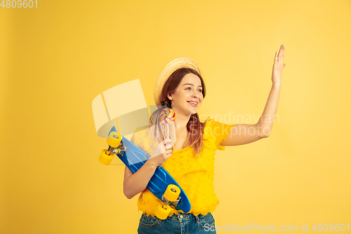 Image of Caucasian woman\'s portrait isolated on yellow studio background