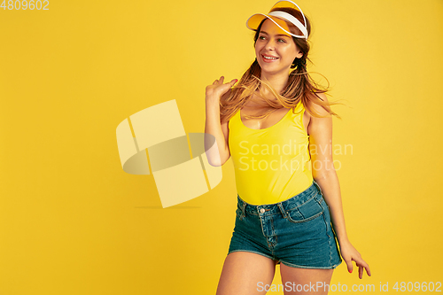 Image of Caucasian woman\'s portrait isolated on yellow studio background