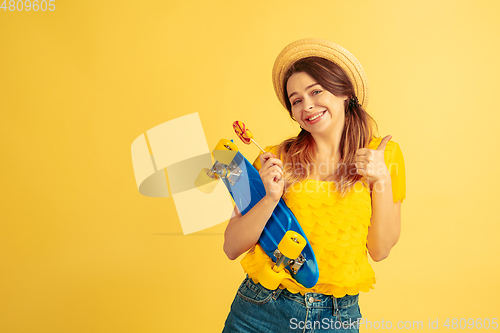 Image of Caucasian woman\'s portrait isolated on yellow studio background