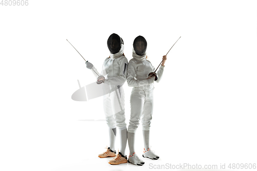 Image of Teen girls in fencing costumes with swords in hands isolated on white background, flyer