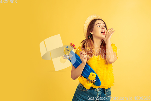 Image of Caucasian woman\'s portrait isolated on yellow studio background