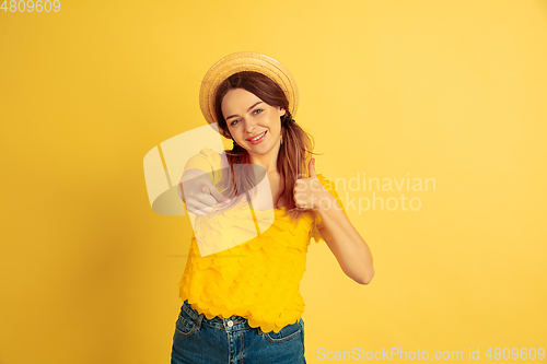 Image of Caucasian woman\'s portrait isolated on yellow studio background