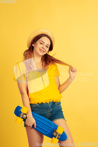 Image of Caucasian woman\'s portrait isolated on yellow studio background