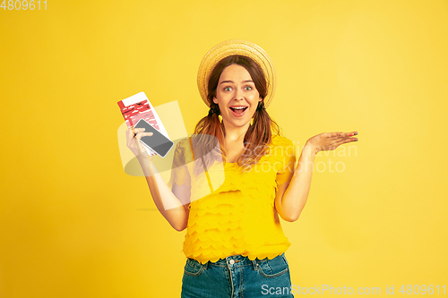 Image of Caucasian woman\'s portrait isolated on yellow studio background