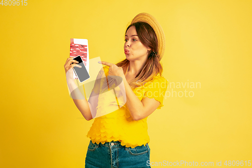 Image of Caucasian woman\'s portrait isolated on yellow studio background