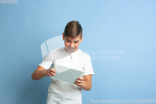 Image of Caucasian teen\'s portrait isolated on blue studio background