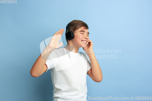 Image of Caucasian teen\'s portrait isolated on blue studio background